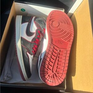 These sneakers are the Nike Air Jordan 1 Retro High OG "Bloodline".